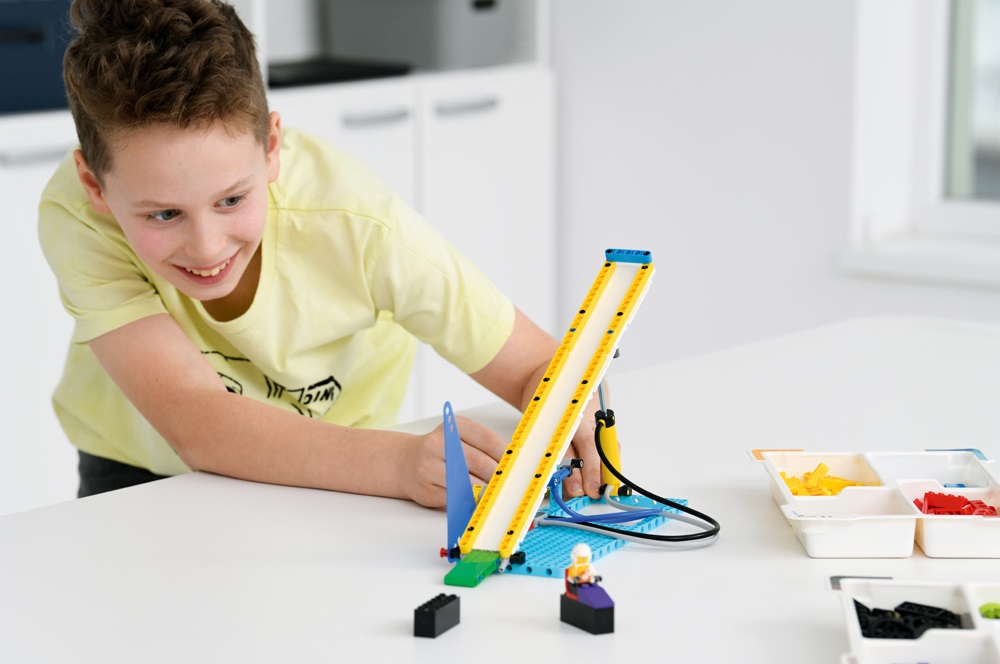 Uczeń eksperymentuje z siłą i ruchem na lekcji fizyki z wykorzystaniem zestawu LEGO Education BricQ Motion Prime